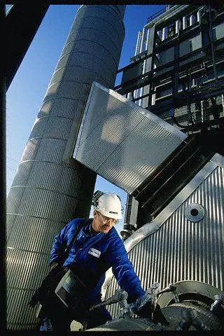 A man in blue jacket and white hard hat.